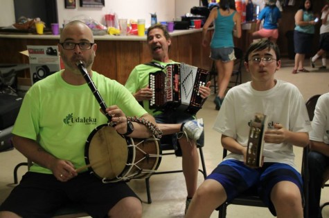 At the camp, the kids are exposed to traditional Basque instruments like the pandero (tambourine), ttunttun (small drum), txistu (recorder) and trikitixa (button accordion).  Teachers this year are Jexux Larrea (back) and Eneko Espino (left. Camper Jean Jules Flesher plays the pandero. (Lisa Corcostegui).